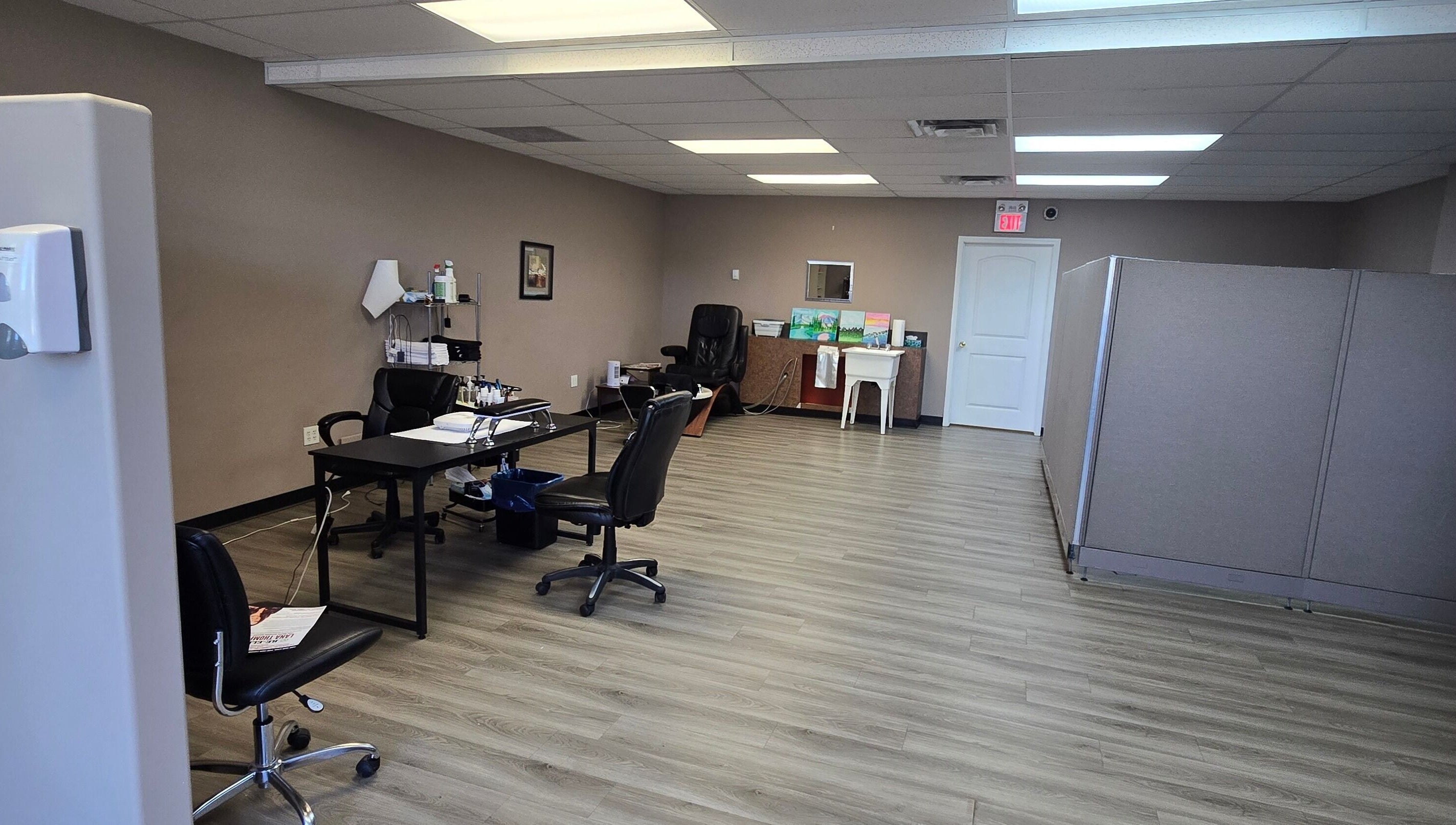 Spacious interior of Sugar and Spice Esthetics in Ponoka, Alberta, CA with modern decor and workstations.