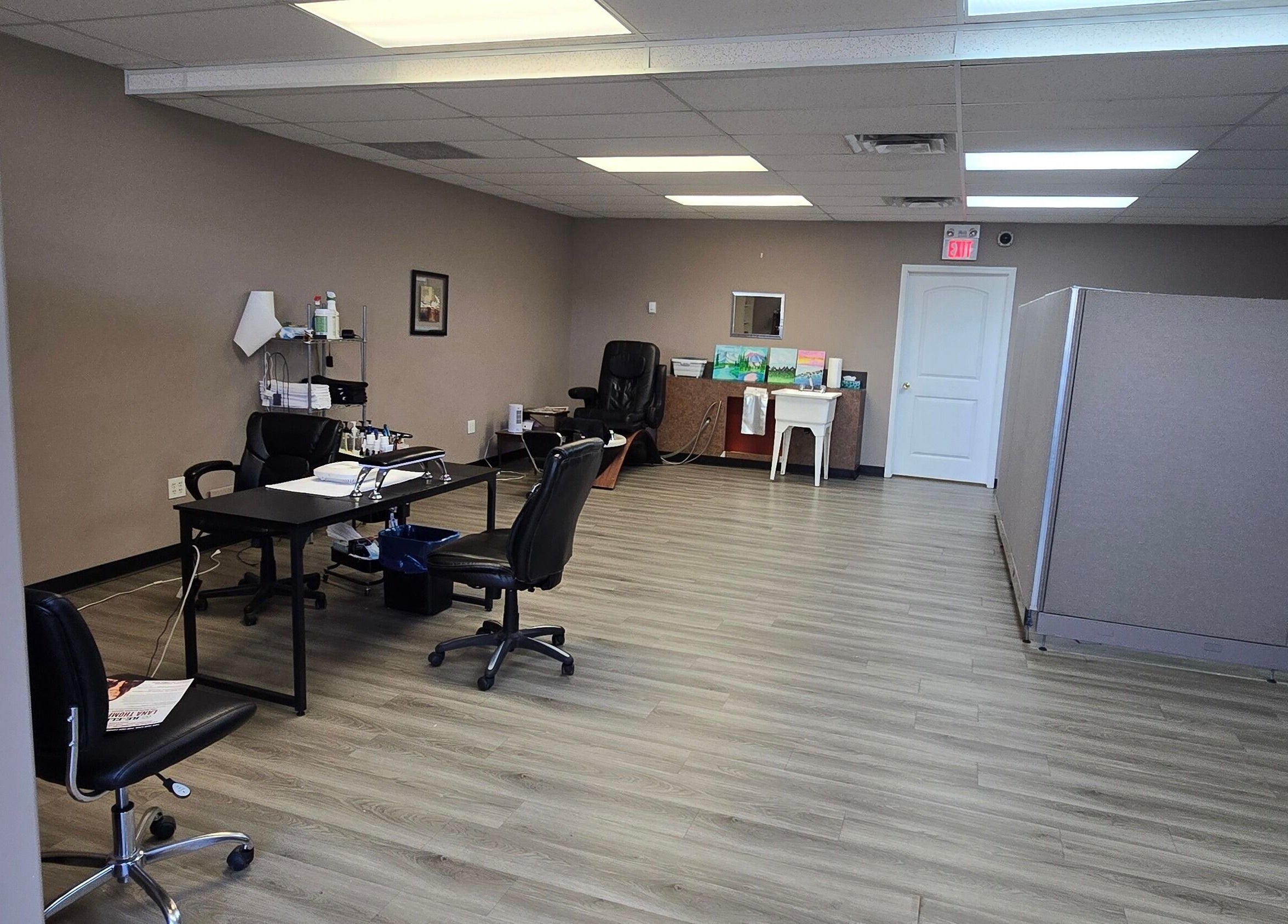 Spacious interior of Sugar and Spice Esthetics in Ponoka, Alberta, CA with modern decor and workstations.