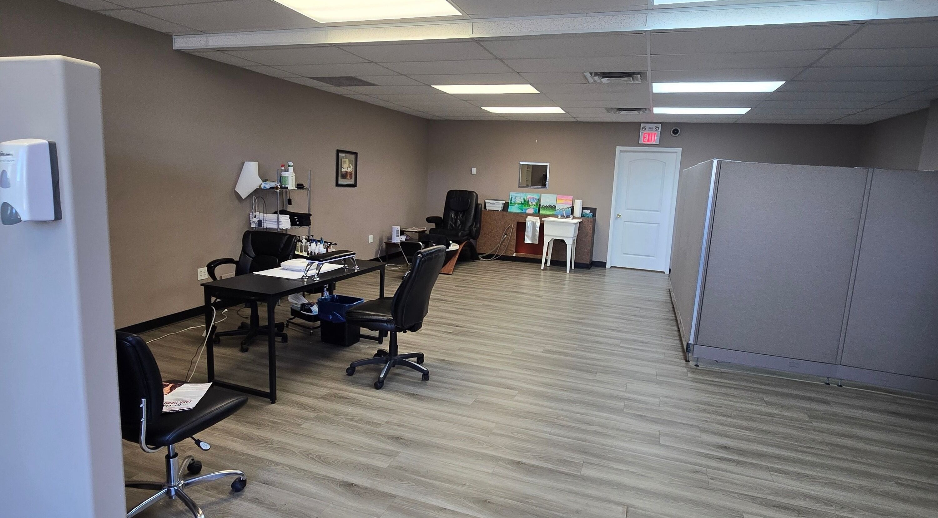 Spacious interior of Sugar and Spice Esthetics in Ponoka, Alberta, CA with modern decor and workstations.