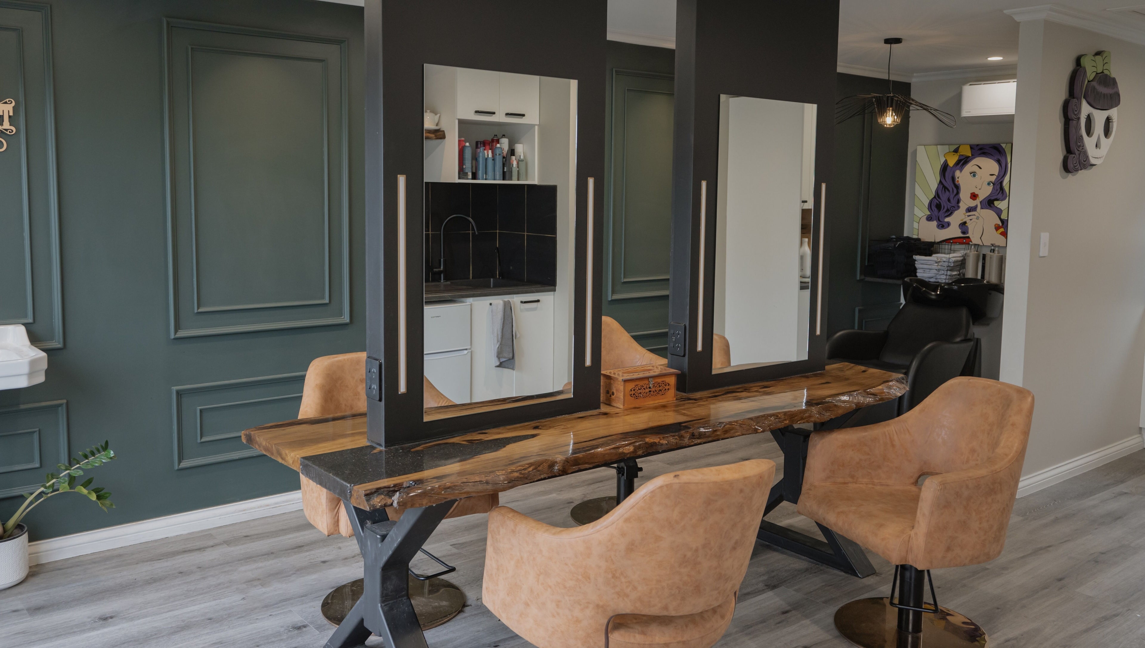 Stylish salon interior at Scarlet Hair Studio, Tauranga, Bay of Plenty, NZ with wooden table and modern chairs.