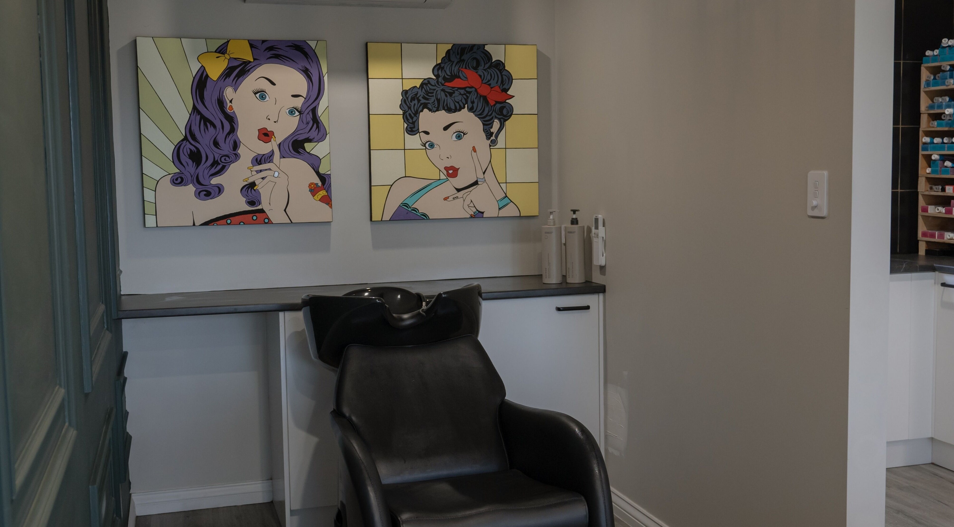 Stylish hair washing station at Scarlet Hair Studio, Tauranga, Bay of Plenty, NZ, featuring pop art decor.