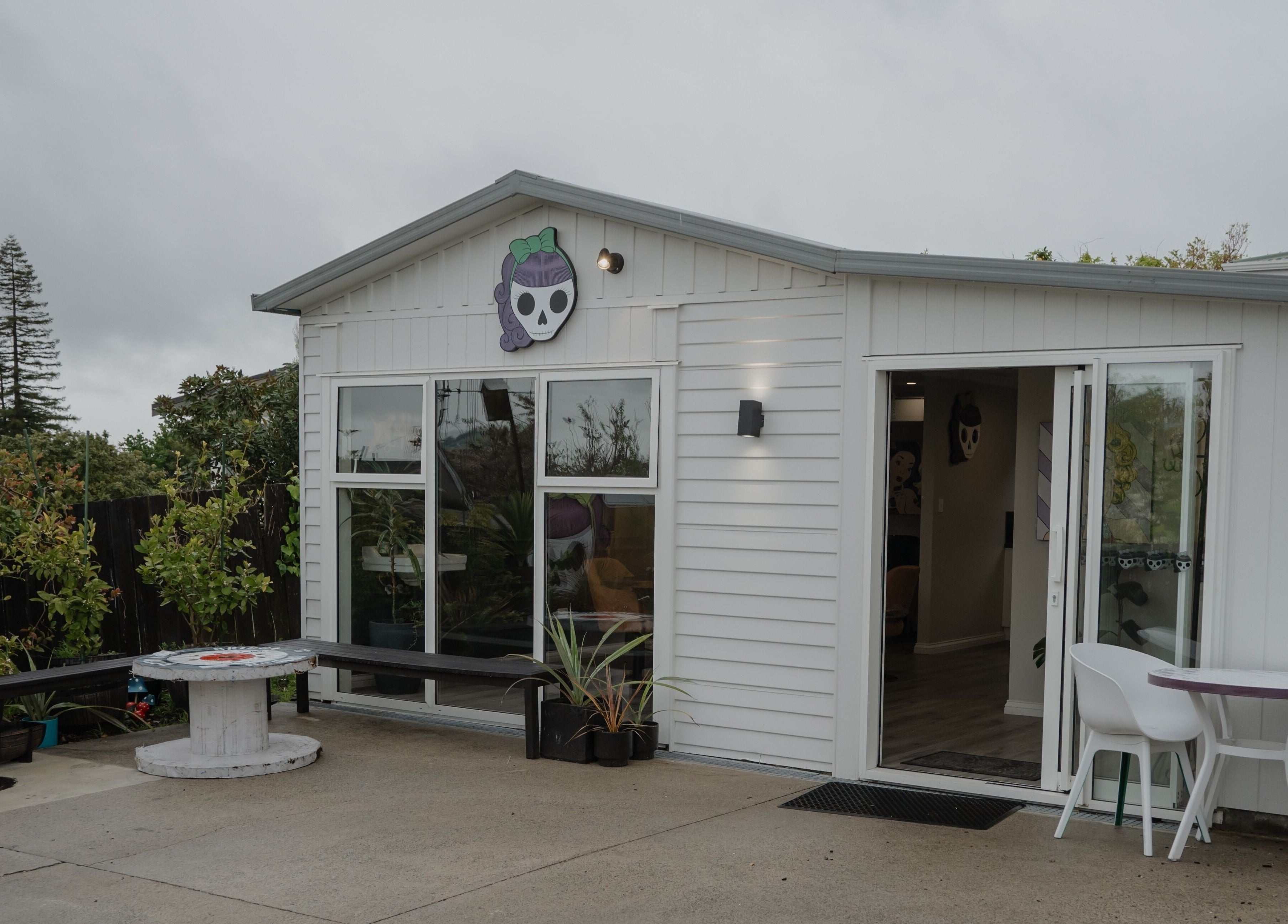 Chic exterior of Scarlet Hair Studio in Tauranga, Bay of Plenty, NZ, featuring a modern white facade.