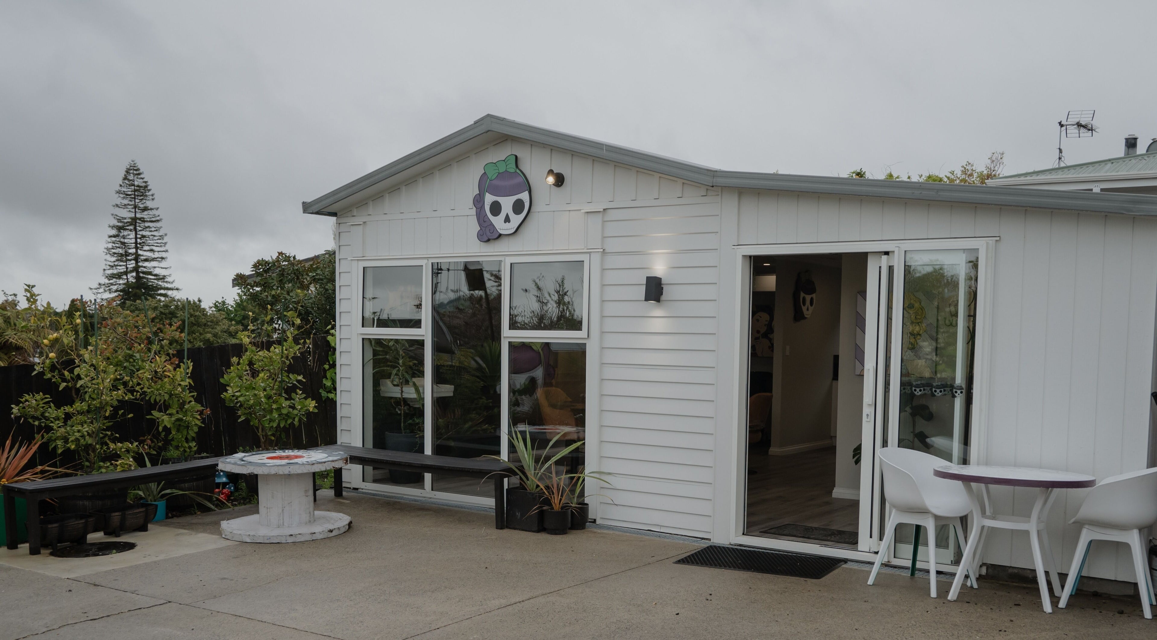 Chic exterior of Scarlet Hair Studio in Tauranga, Bay of Plenty, NZ, featuring a modern white facade.