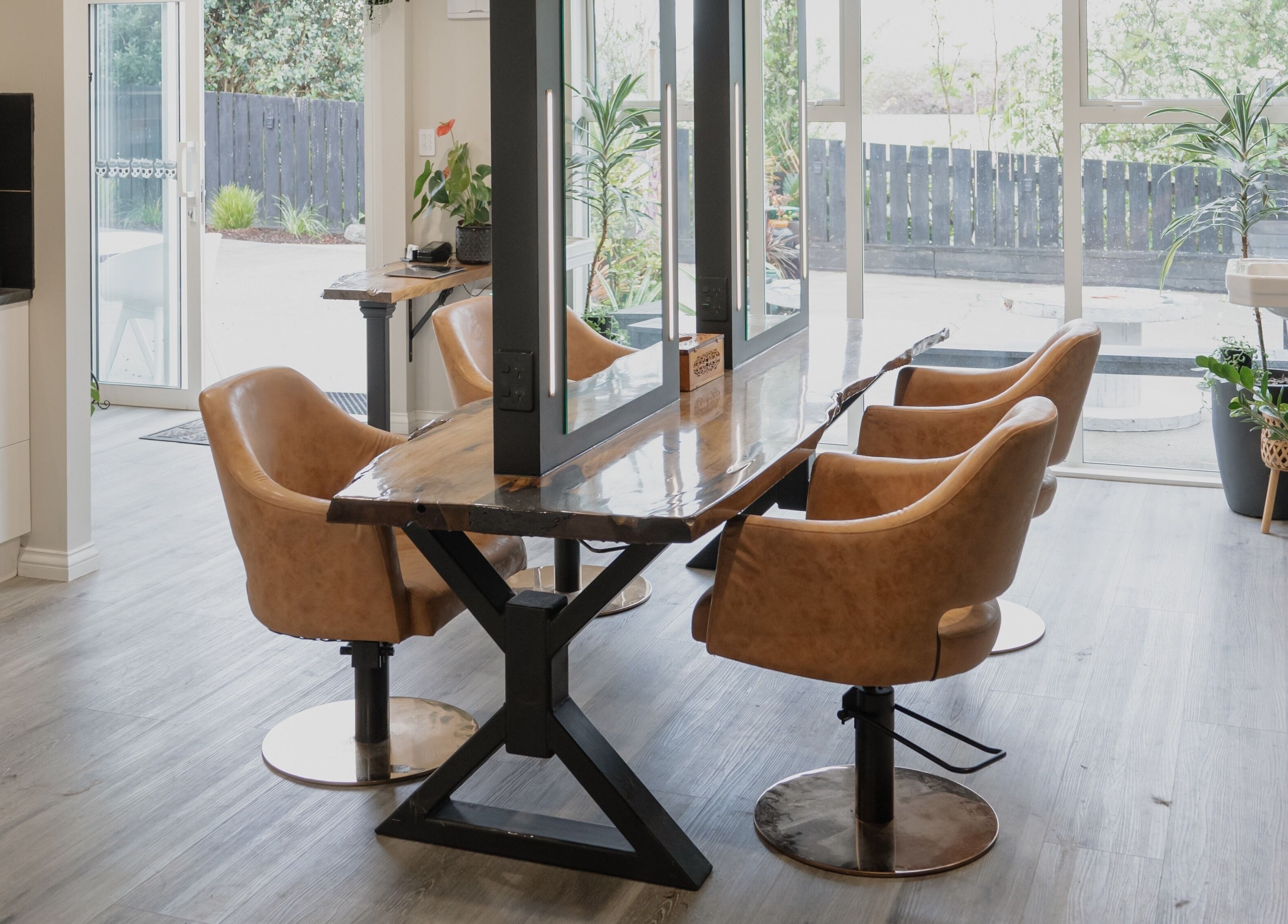 Modern interior of Scarlet Hair Studio in Tauranga, Bay of Plenty, NZ with sleek styling stations and natural light.