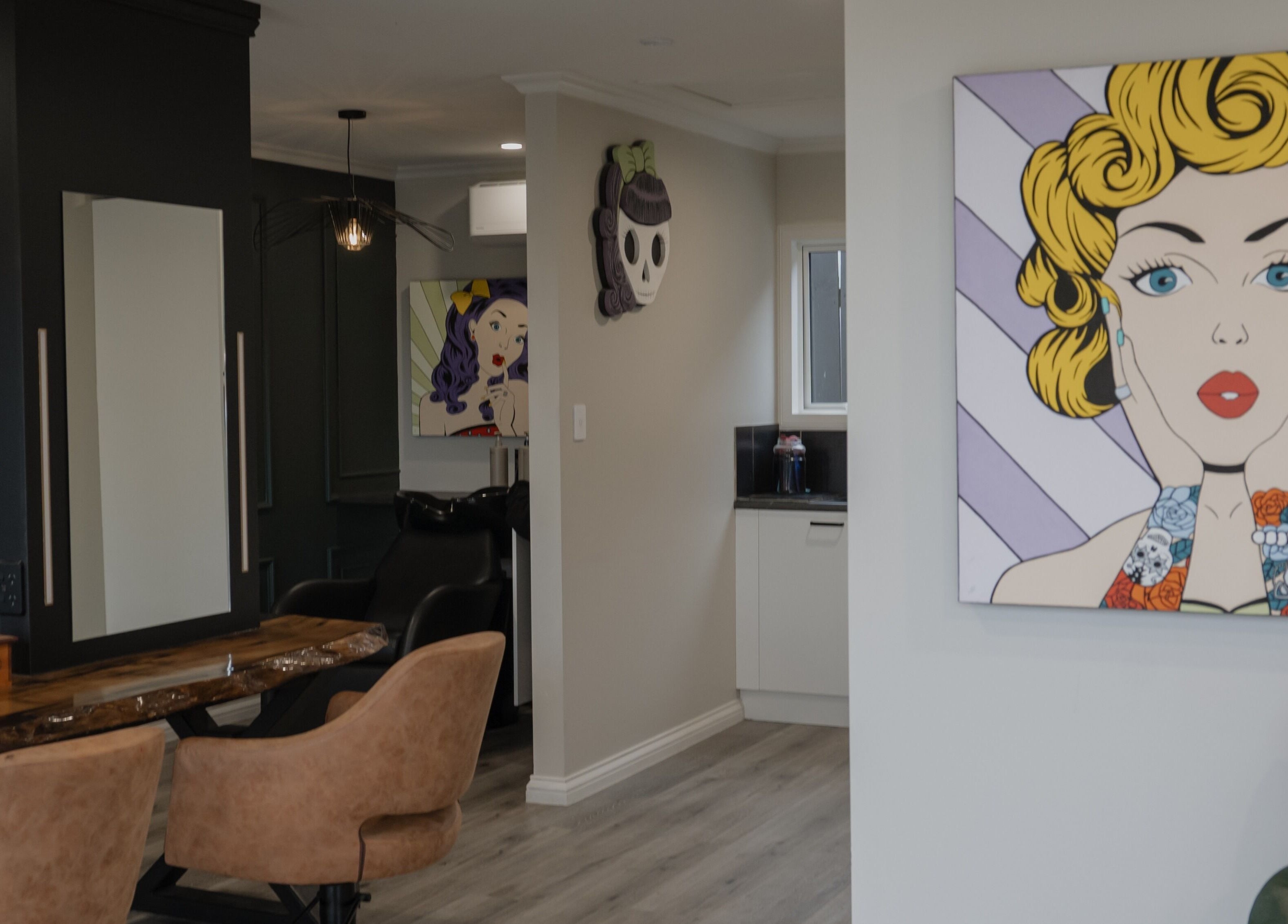 Stylish interior of Scarlet Hair Studio in Tauranga, Bay of Plenty, NZ, featuring modern decor and pop art.