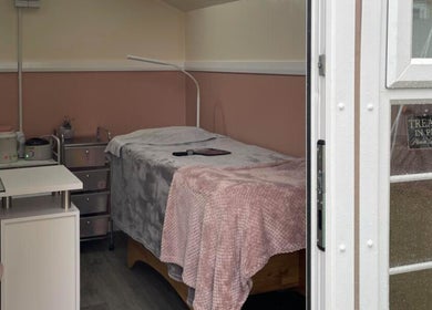 Cozy beauty room at House of Beauty by Tanya, Peterborough, England, GB, featuring a treatment bed and soft lighting.