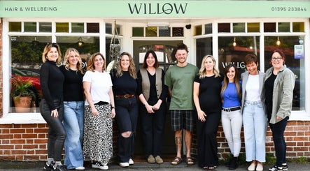 Team at Willow Hair and Wellbeing, Woodbury, England, GB, smiling outside the salon.