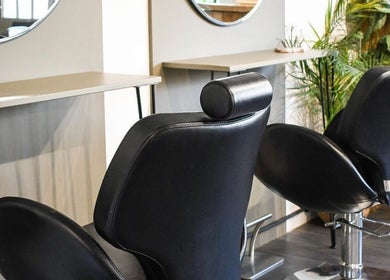 Modern salon chairs at Willow Hair and Wellbeing, Woodbury, England, GB enhancing a stylish ambiance.