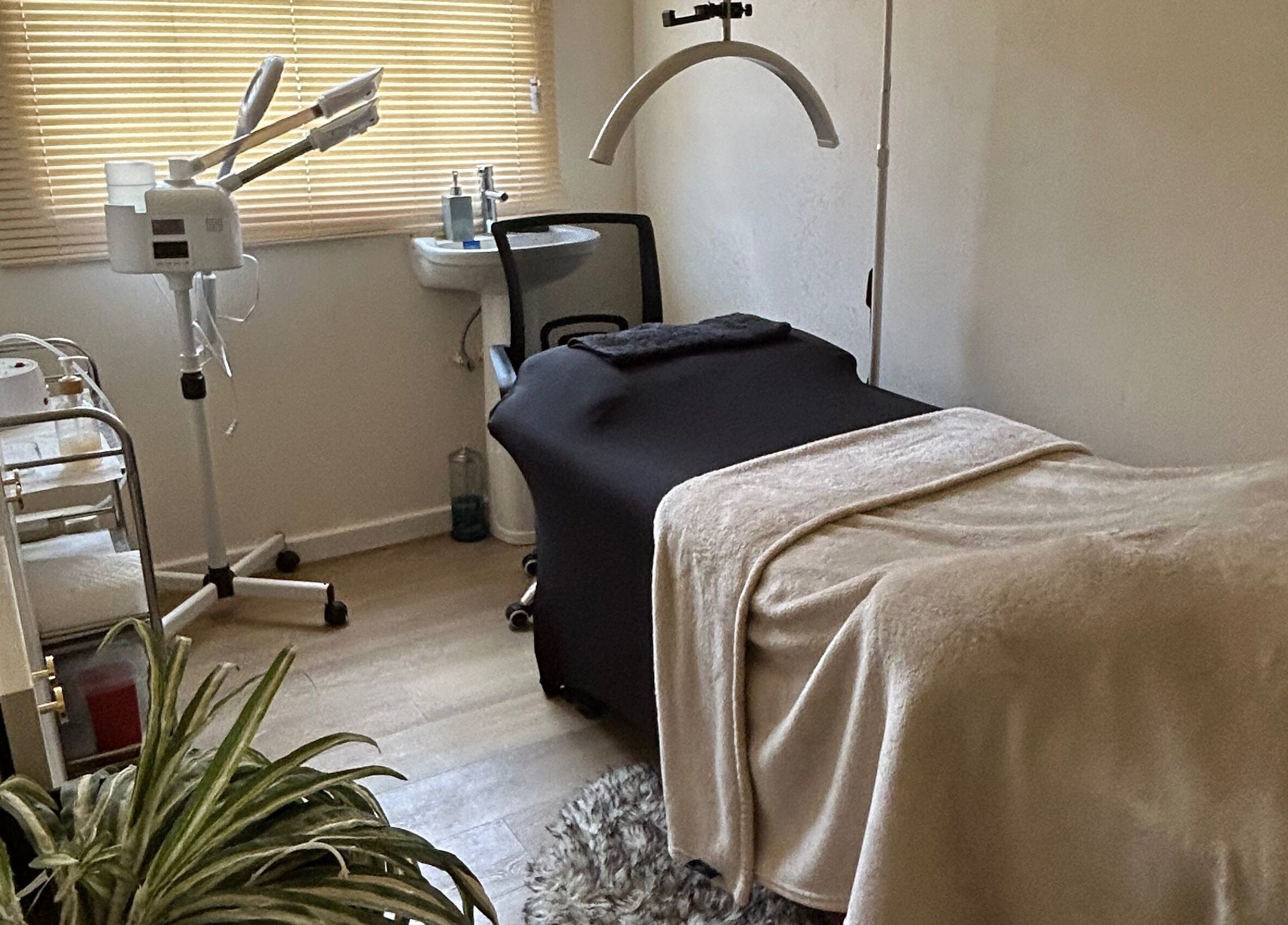 Tranquil treatment room at Solitude Esthetics in Oistins, Christ Church, BB, featuring massage table and skincare equipment.