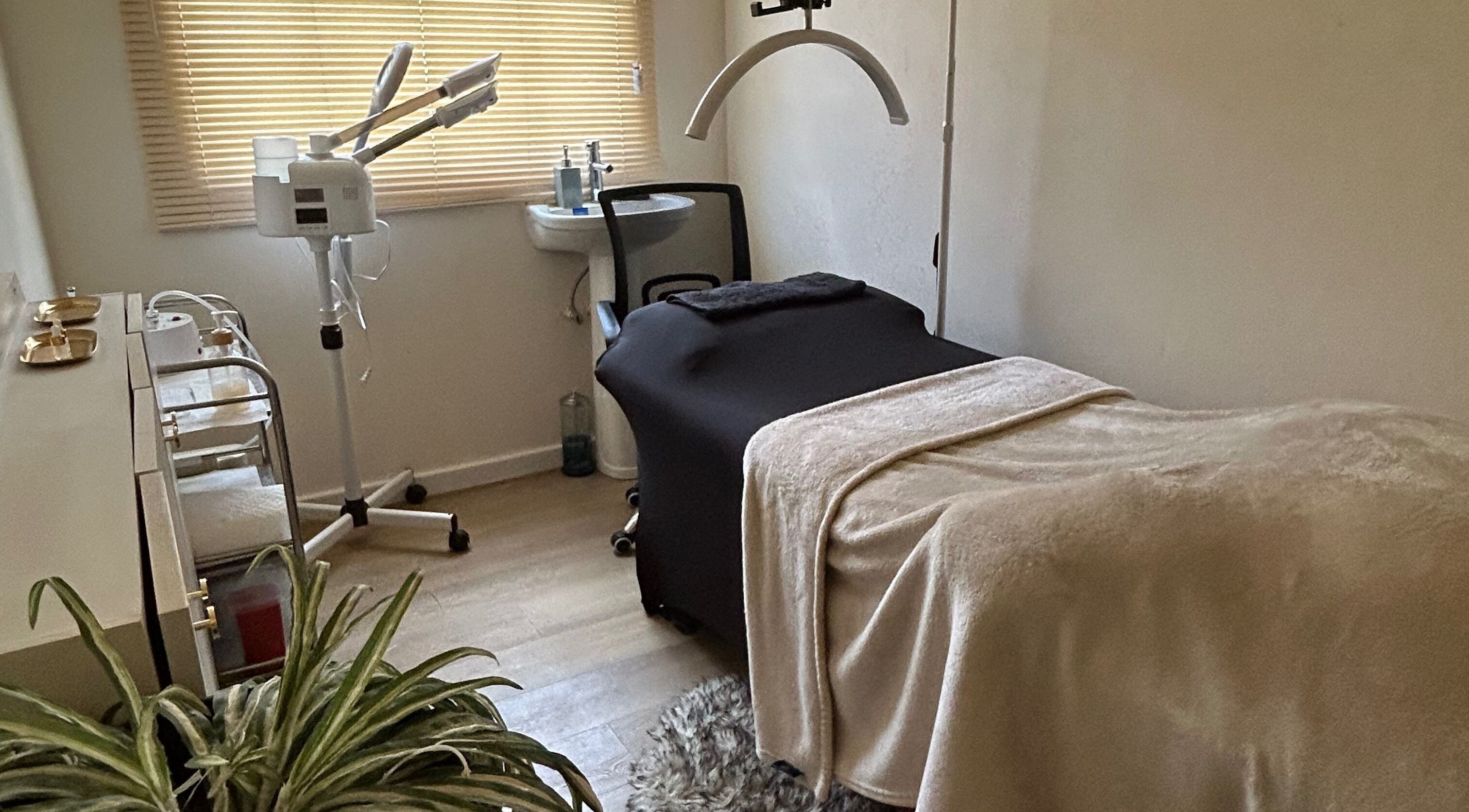 Tranquil treatment room at Solitude Esthetics in Oistins, Christ Church, BB, featuring massage table and skincare equipment.