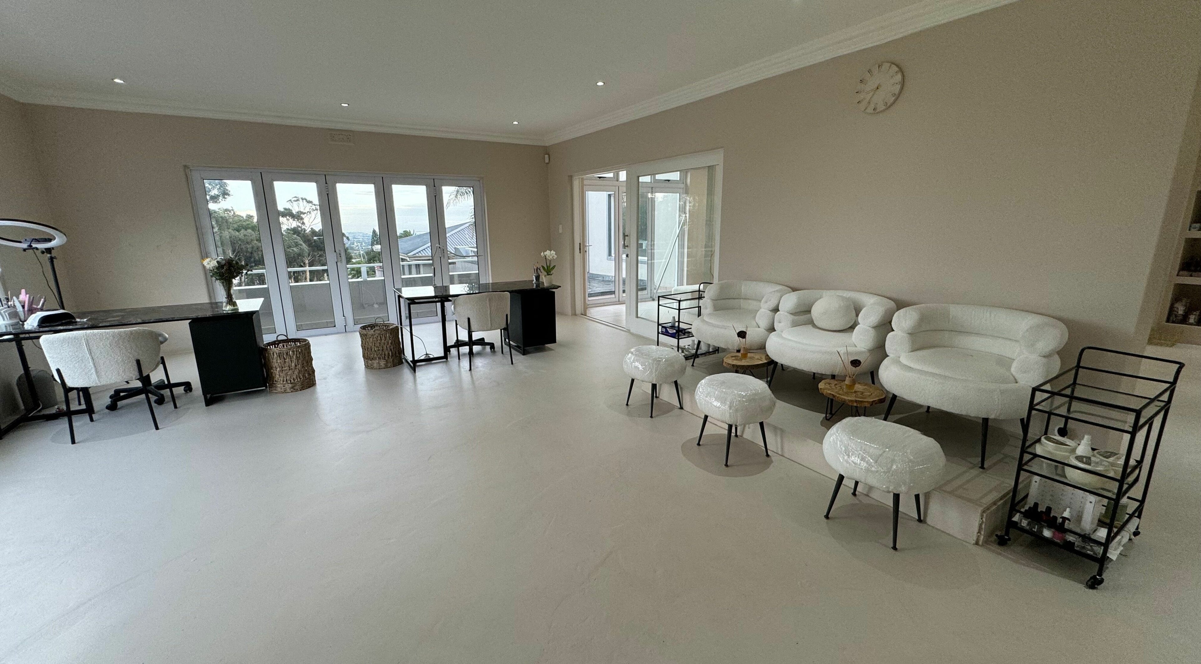 Bright interior of Capri Academy and Clinic in Cape Town, Western Cape, ZA with white chairs and modern design.