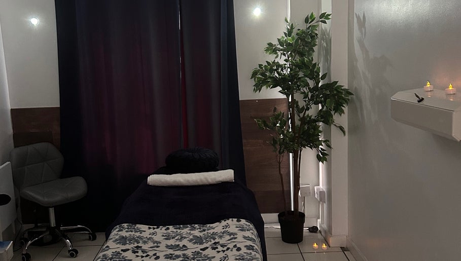 Relaxing massage room at The Facial Spa at Bank House, Llantwit Major, Wales, GB, featuring a cozy bed and soft lighting.