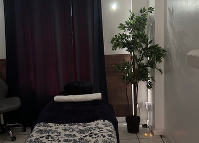 Relaxing massage room at The Facial Spa at Bank House, Llantwit Major, Wales, GB, featuring a cozy bed and soft lighting.