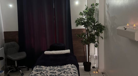 Relaxing massage room at The Facial Spa at Bank House, Llantwit Major, Wales, GB, featuring a cozy bed and soft lighting.