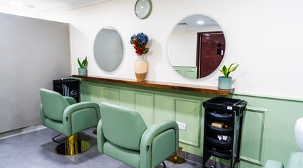 Elegant interior of Wandies Hair and Beauty Salon in Sharjah, AE with modern green chairs and mirrors.