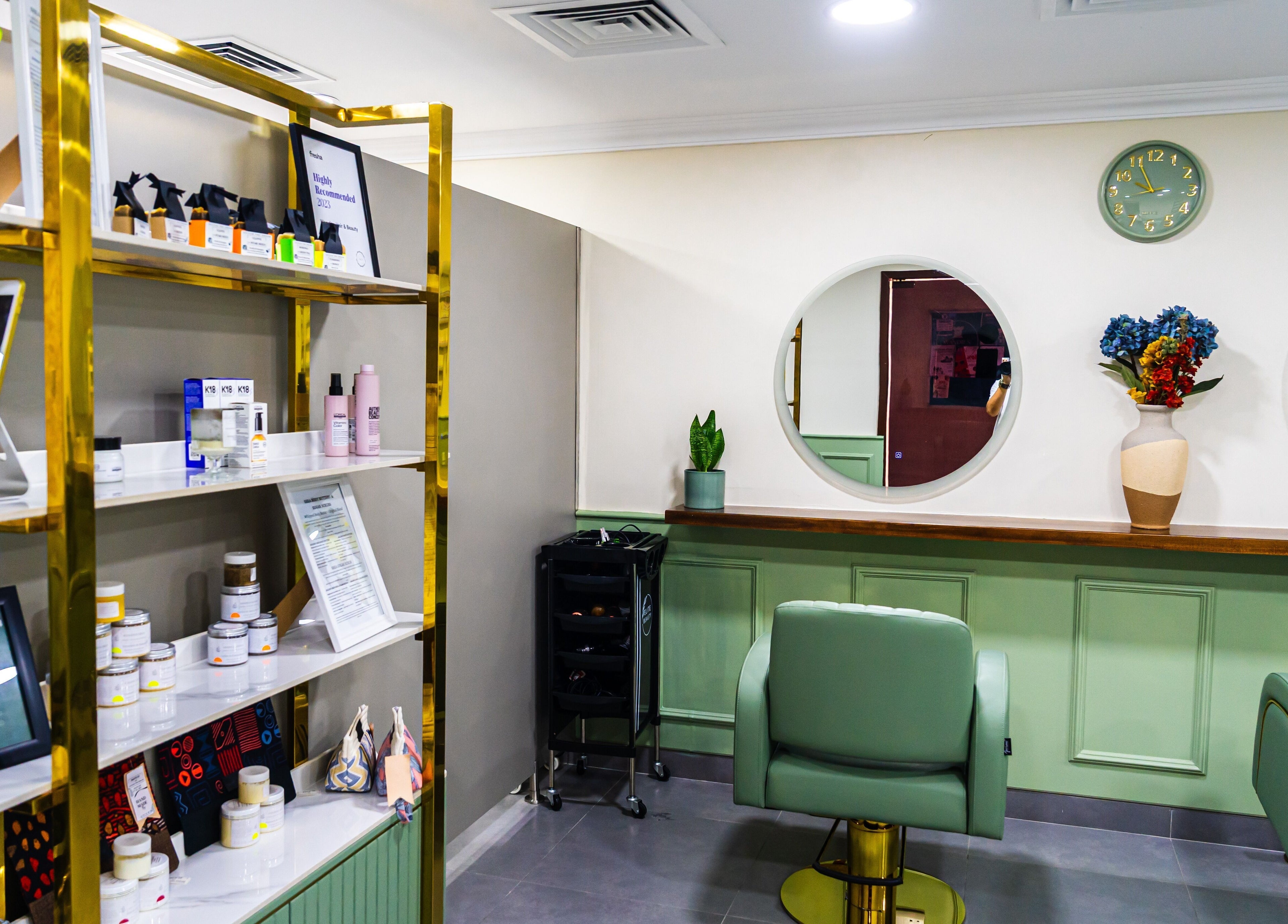 Modern interior of Wandies Hair and Beauty Salon in Sharjah, AE, featuring chic chairs and beauty products.