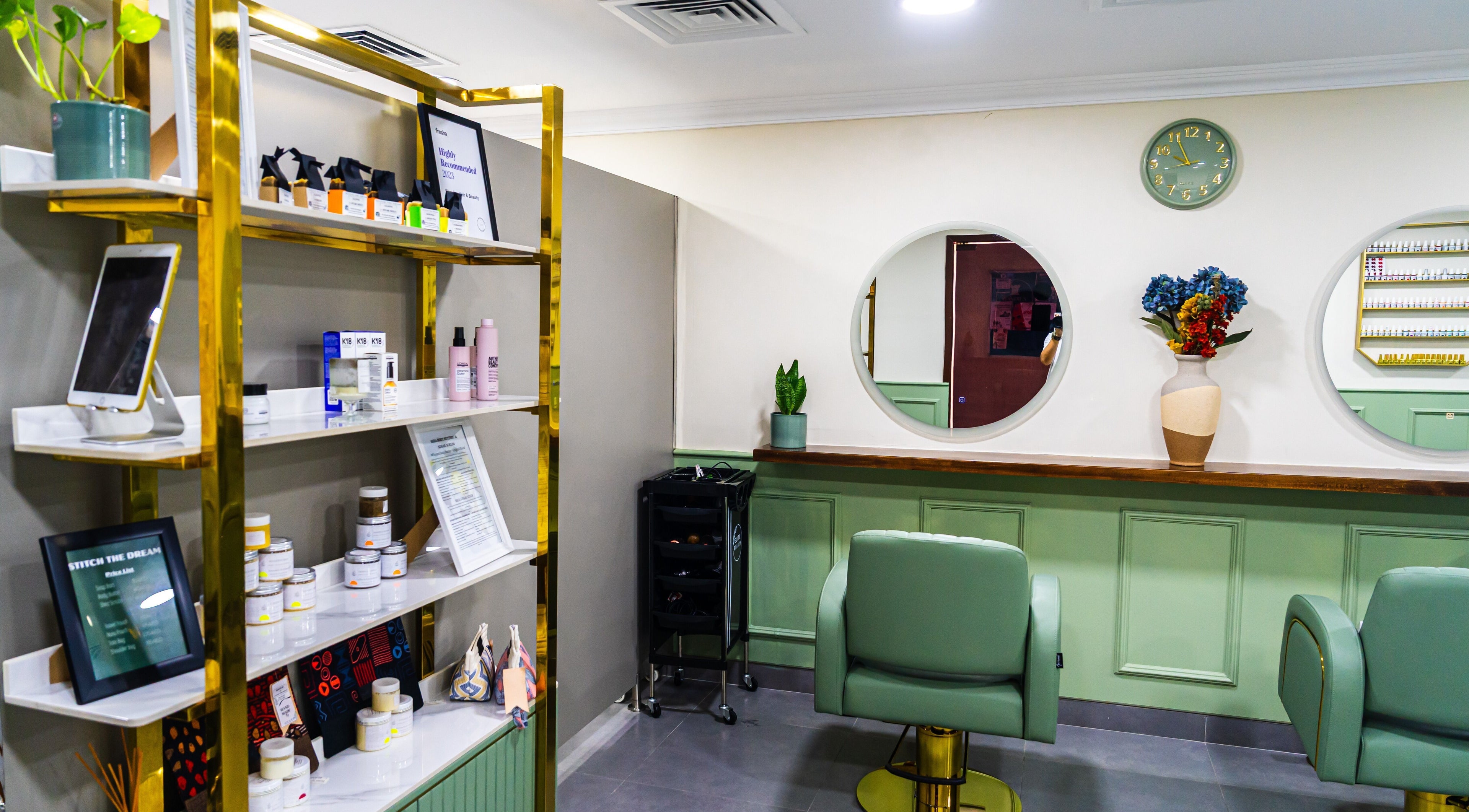 Modern interior of Wandies Hair and Beauty Salon in Sharjah, AE, featuring chic chairs and beauty products.