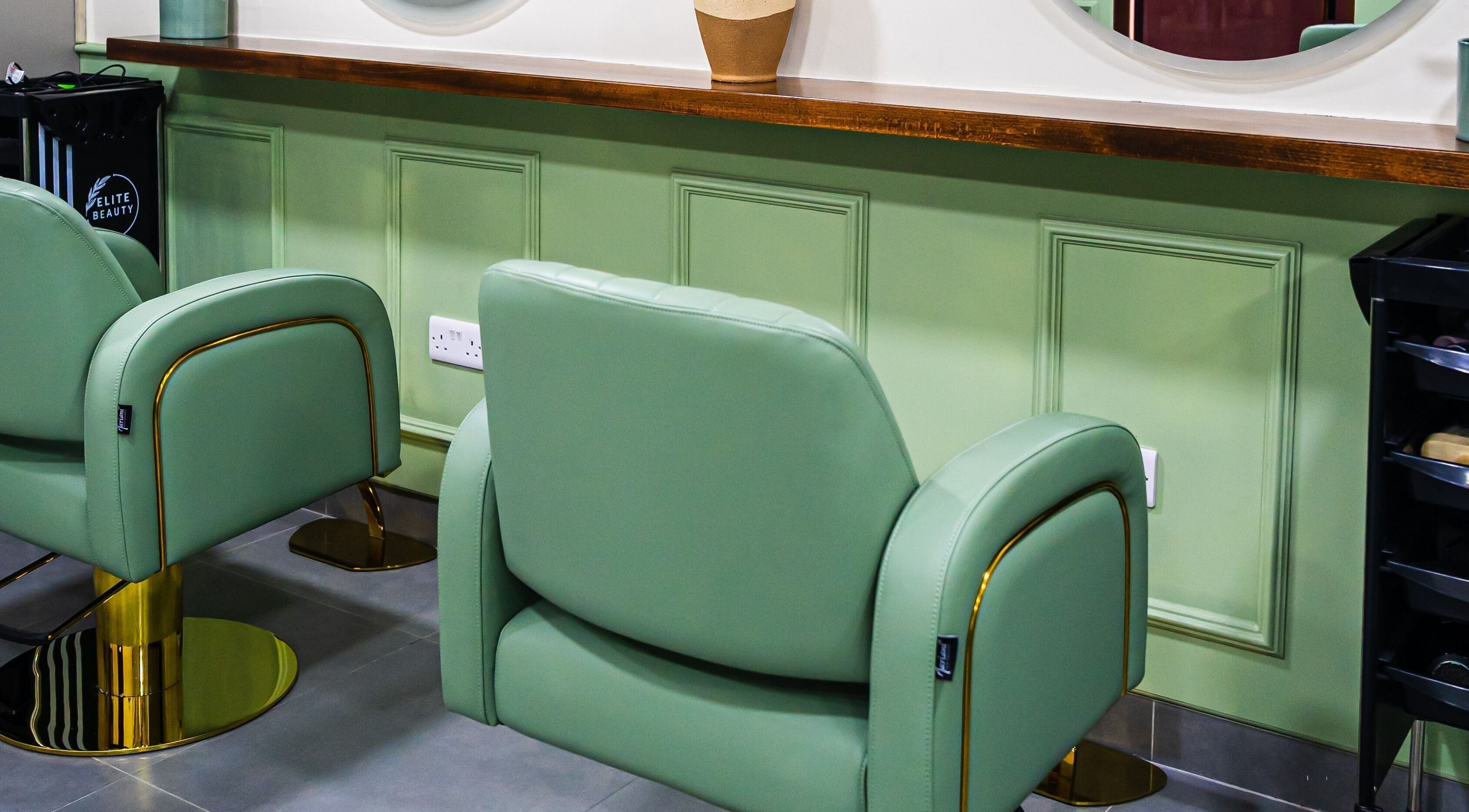 Stylish green salon chairs at Wandies Hair and Beauty Salon in Sharjah, AE, showcasing comfort and luxury.