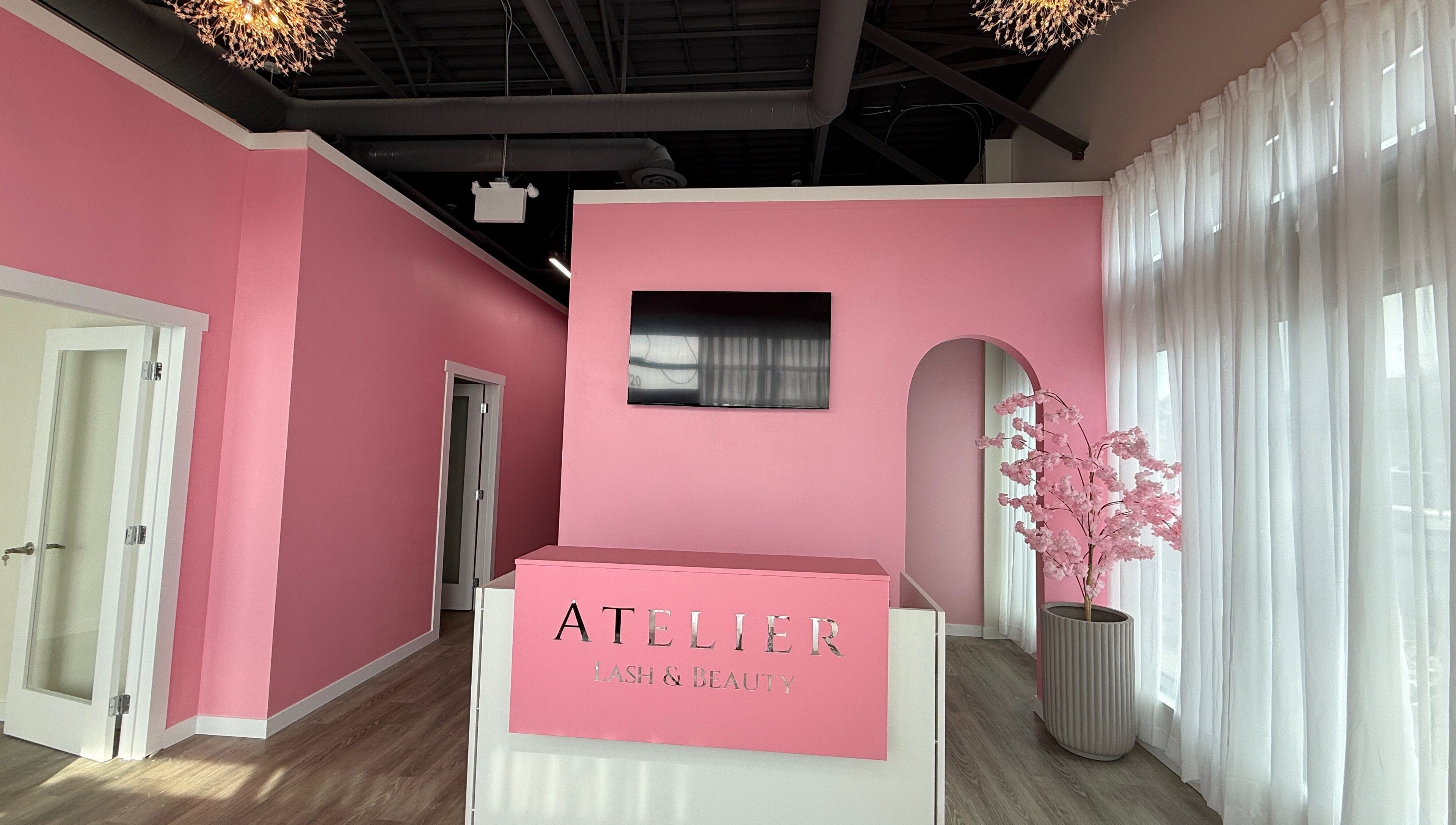 Chic pink reception at The Beauty Nurs in Edmonton, Alberta, CA, featuring modern decor and ambient lighting.