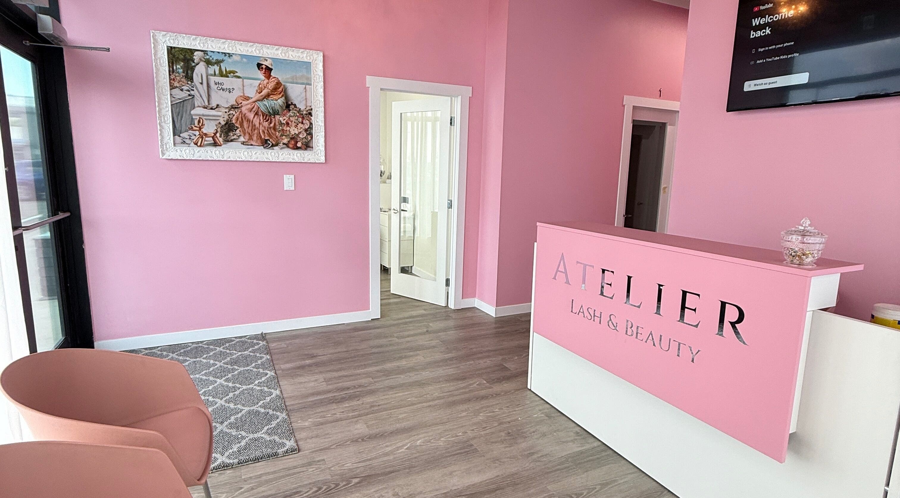 The Beauty Nurs Edmonton reception area with pink decor and welcoming ambiance.