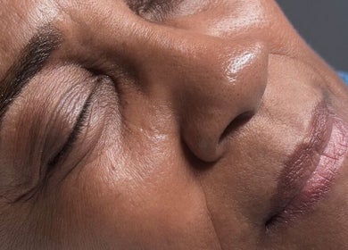 Close-up of a woman's serene face with closed eyes at Vela Lash Bar, Jacksonville, Florida, US.