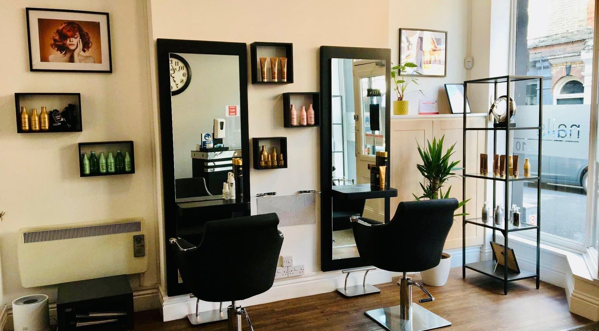Elegant interior of Tracey Taylor Hair salon in Newton Abbot, GB, featuring modern styling chairs and products.