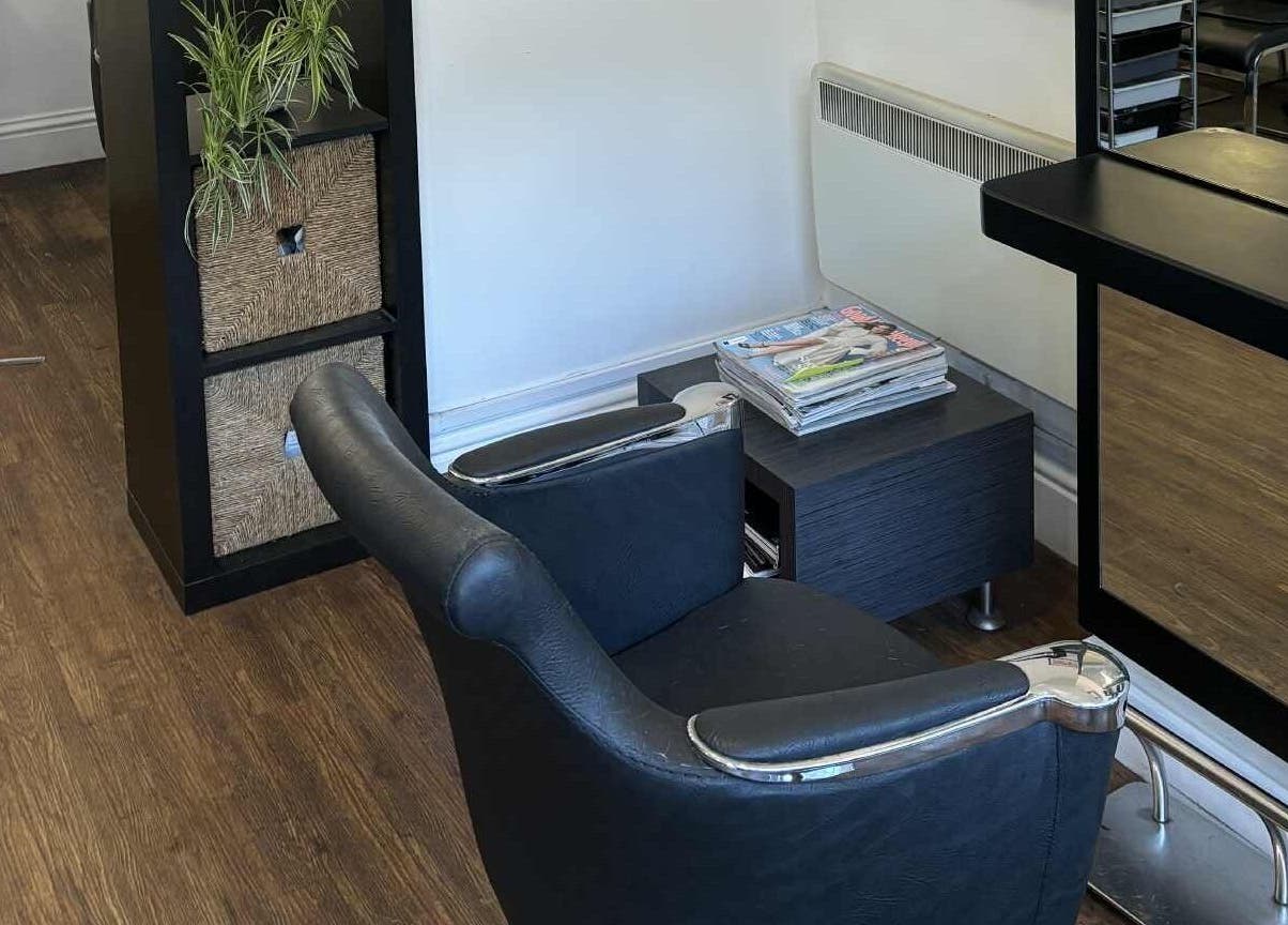 Chic salon interior at Tracey Taylor Hair in Newton Abbot, GB featuring a stylish chair and sleek mirror.