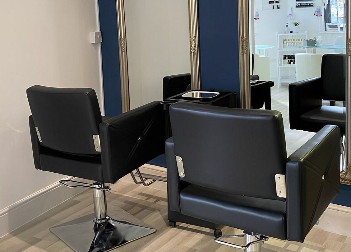 Chic salon interior with mirrors and chairs at Belle’s Boutique, East Grinstead, England, GB.