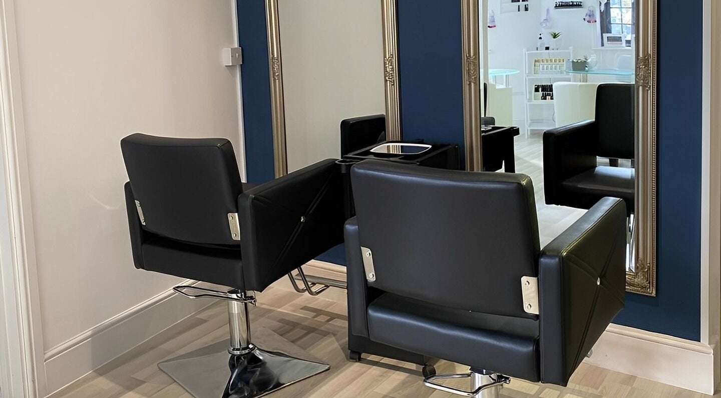 Chic salon interior with mirrors and chairs at Belle’s Boutique, East Grinstead, England, GB.