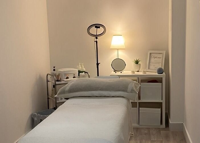 Tranquil treatment room at Belle's Boutique, East Grinstead, England, GB, featuring a cozy massage bed and calming decor.