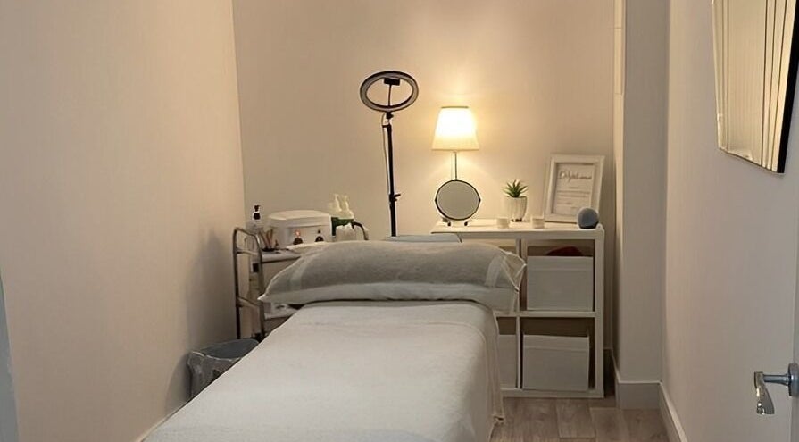 Tranquil treatment room at Belle's Boutique, East Grinstead, England, GB, featuring a cozy massage bed and calming decor.