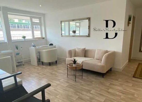 Bright, elegant interior of Belle's Boutique in East Grinstead, England, GB featuring plush seating and decor.