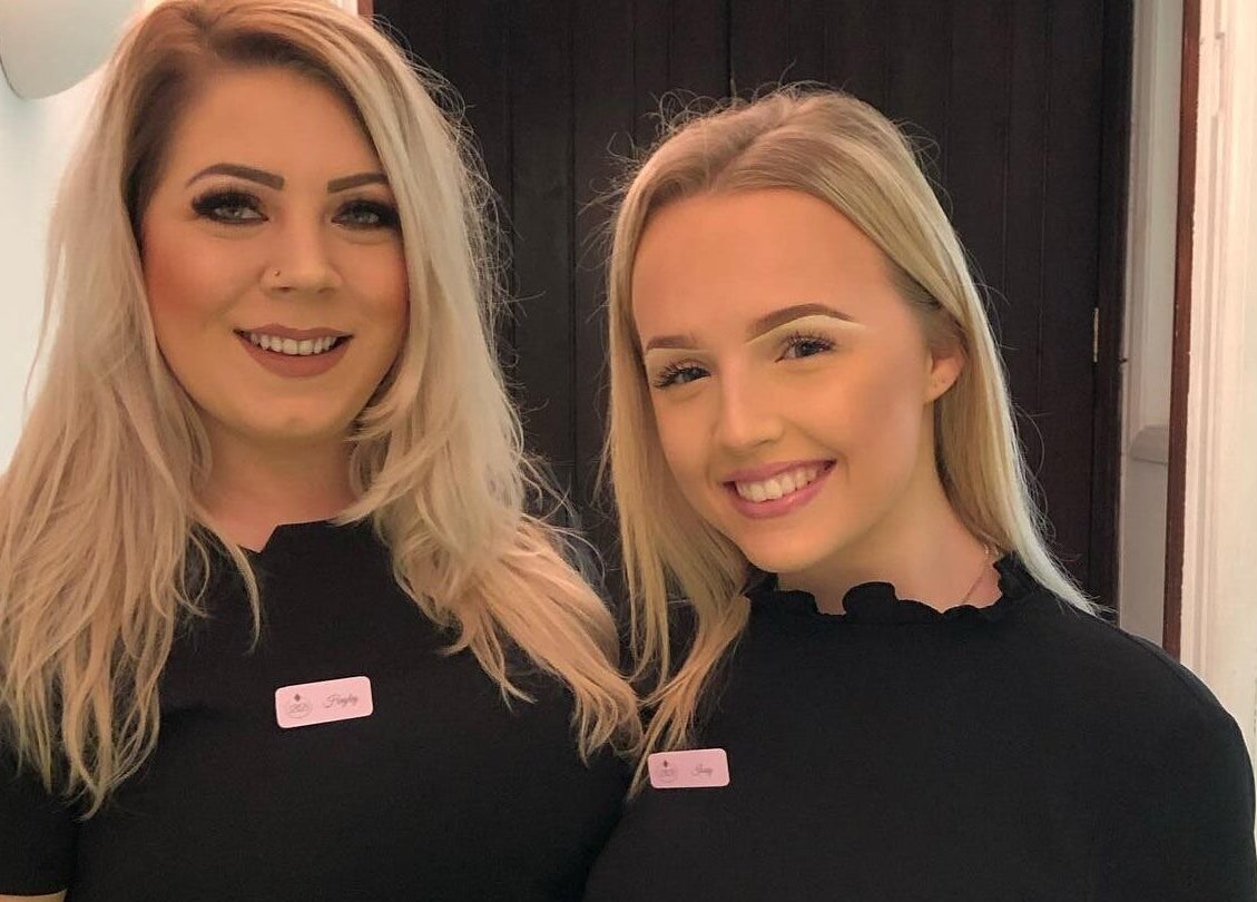 Staff members smiling at Belle's Boutique, East Grinstead, England, GB, offering beauty and wellness services.