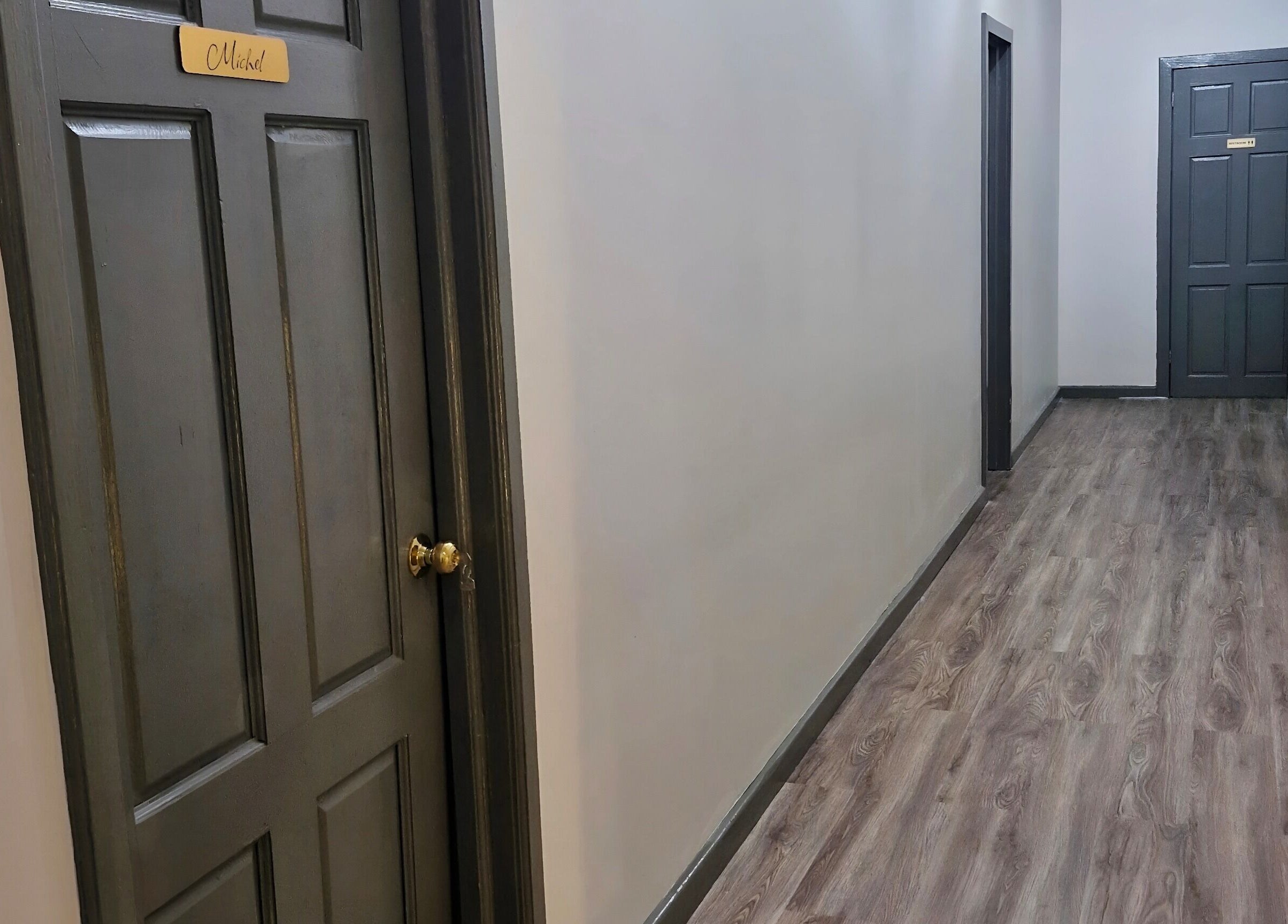 Sleek hallway at SkinFirst Esthetics & Academy, La Tourney, Vieux Fort, LC, featuring elegant doors and flooring.