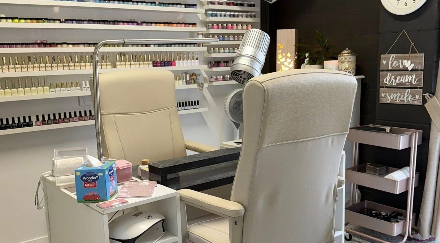 Cozy nail station at Glam Time Nail Studio in Molendinar, Queensland, AU, featuring organized polish display.