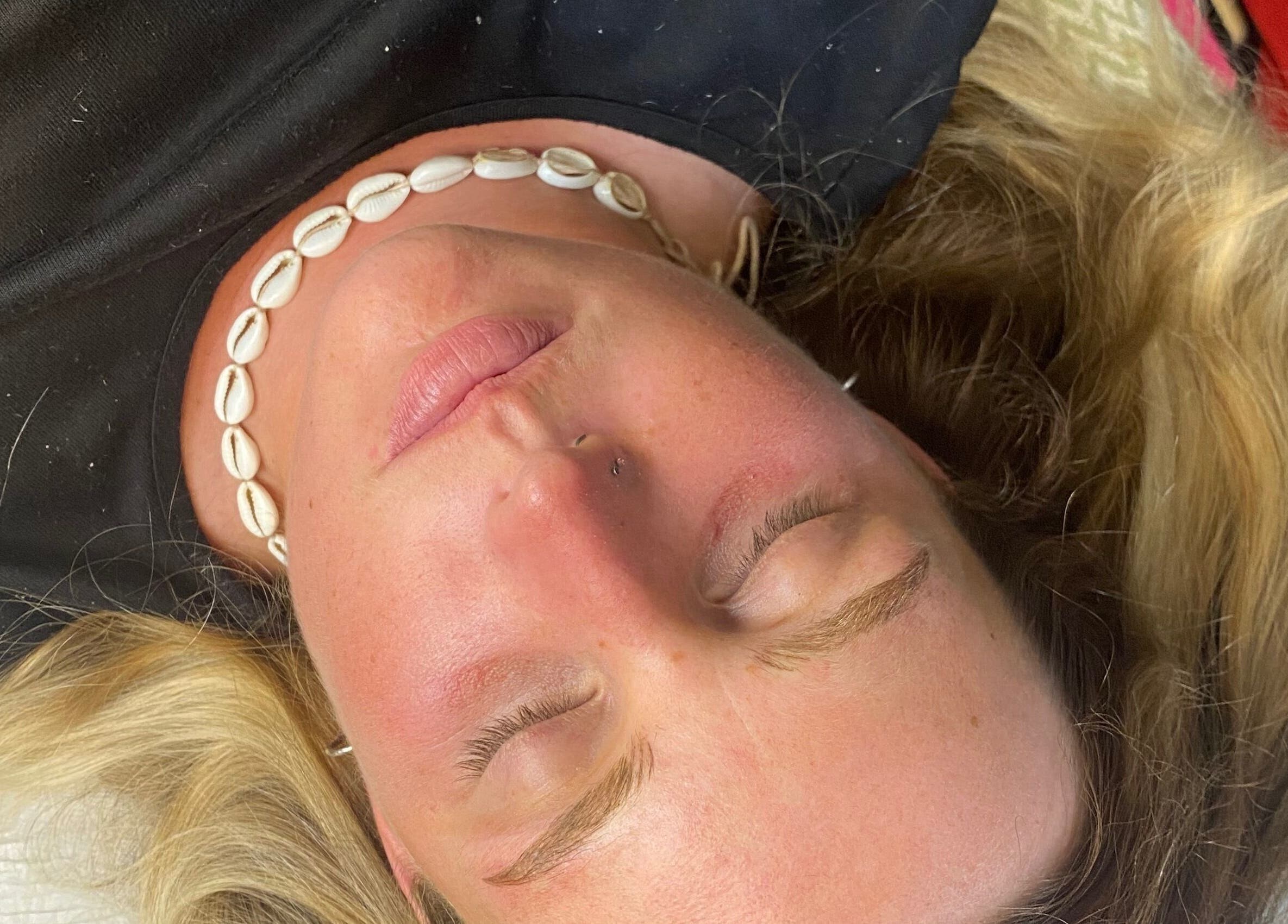 Client with closed eyes receiving service at Lashes and Brows by Katy, Gloucester, England, GB.