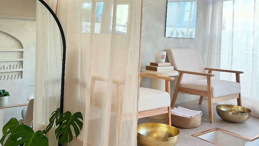 Elegant nail spa seating at Kyra Dennison Nails, Plymouth, England, GB with chic decor and golden bowls.