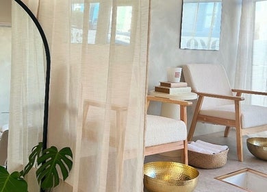 Elegant nail spa seating at Kyra Dennison Nails, Plymouth, England, GB with chic decor and golden bowls.