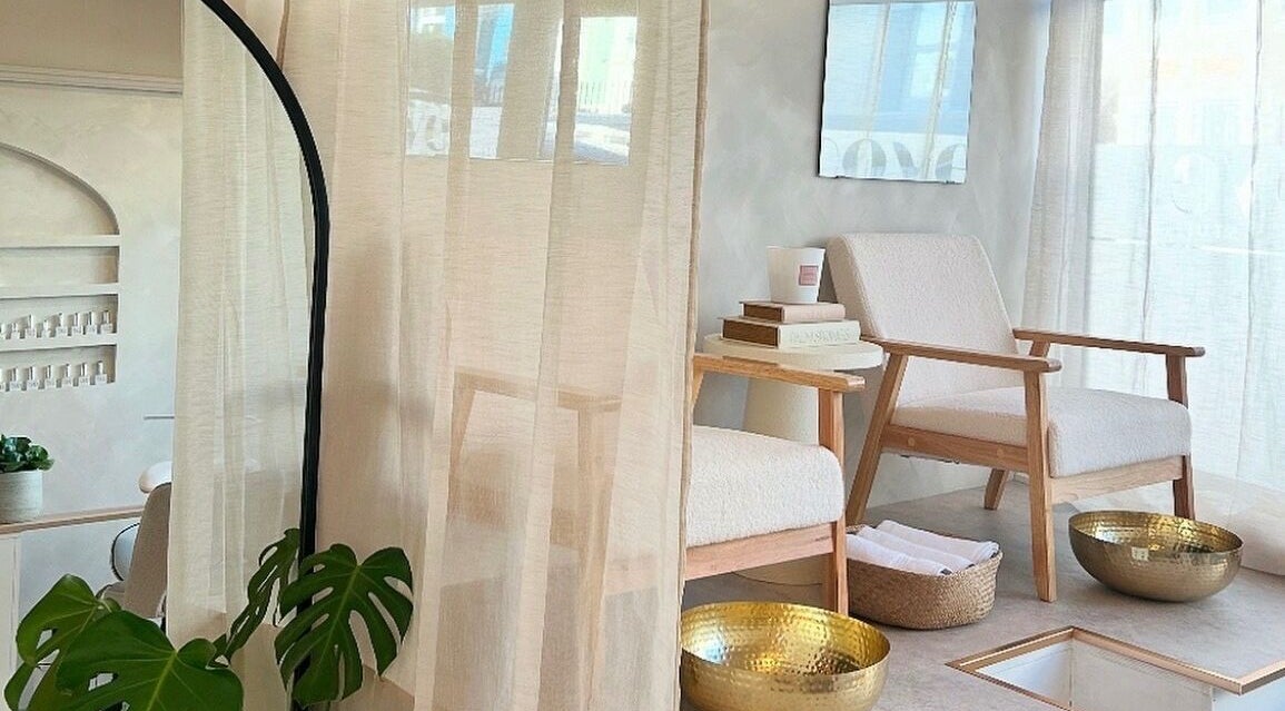 Elegant nail spa seating at Kyra Dennison Nails, Plymouth, England, GB with chic decor and golden bowls.
