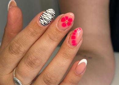Stylish nail art with zebra and floral designs at Kyra Dennison Nails, Plymouth, England, GB.