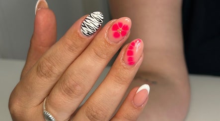 Stylish nail art with zebra and floral designs at Kyra Dennison Nails, Plymouth, England, GB.