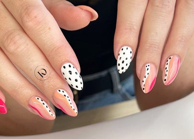 Stylish polka dot nails at Kyra Dennison Nails, Plymouth, England, GB. Vibrant patterns with a modern twist.