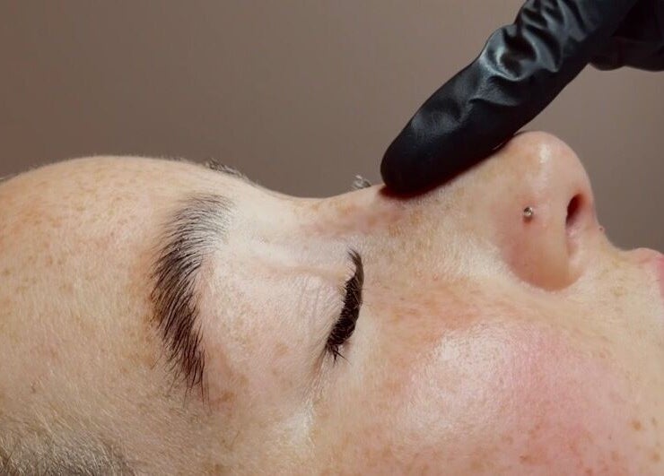 Relaxing facial at Face by Demi in Hook, England, GB with gentle black-gloved touch.