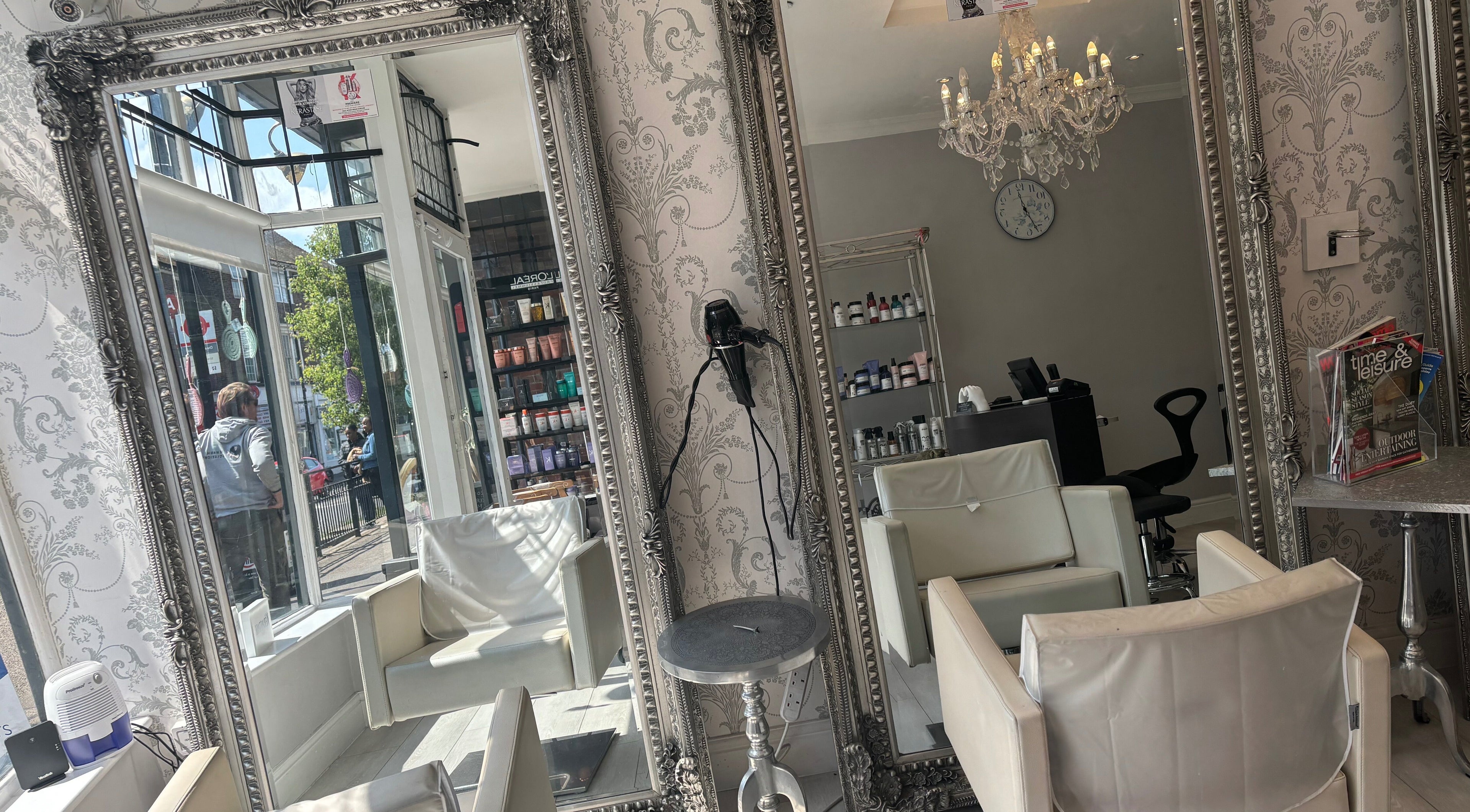 Chic interior of Emma Louise Hair salon in Sutton, England, GB with ornate mirrors and elegant seating.
