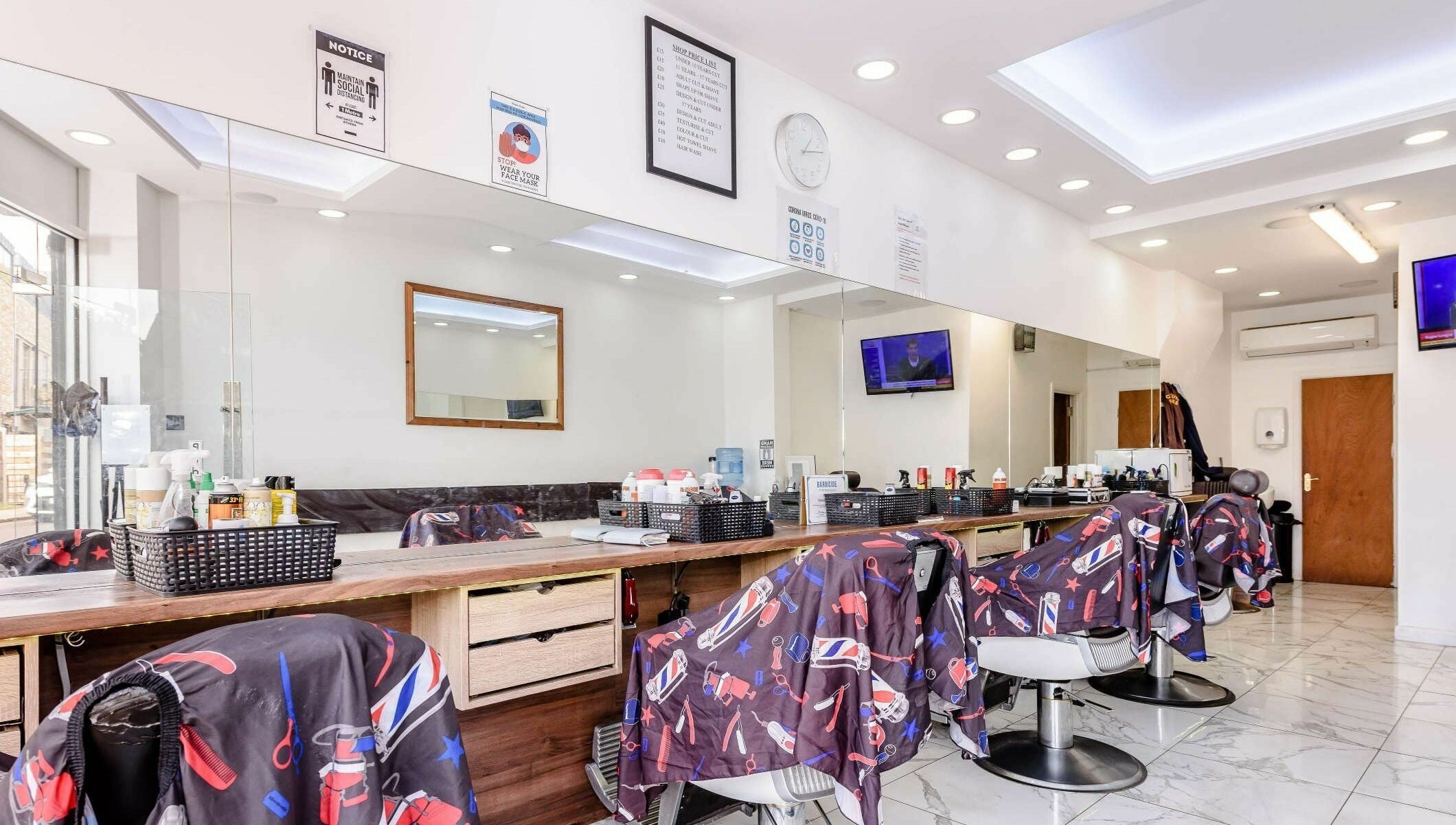 Clean Cuts London interior showcasing sleek barber chairs and mirrors. London, England, GB.