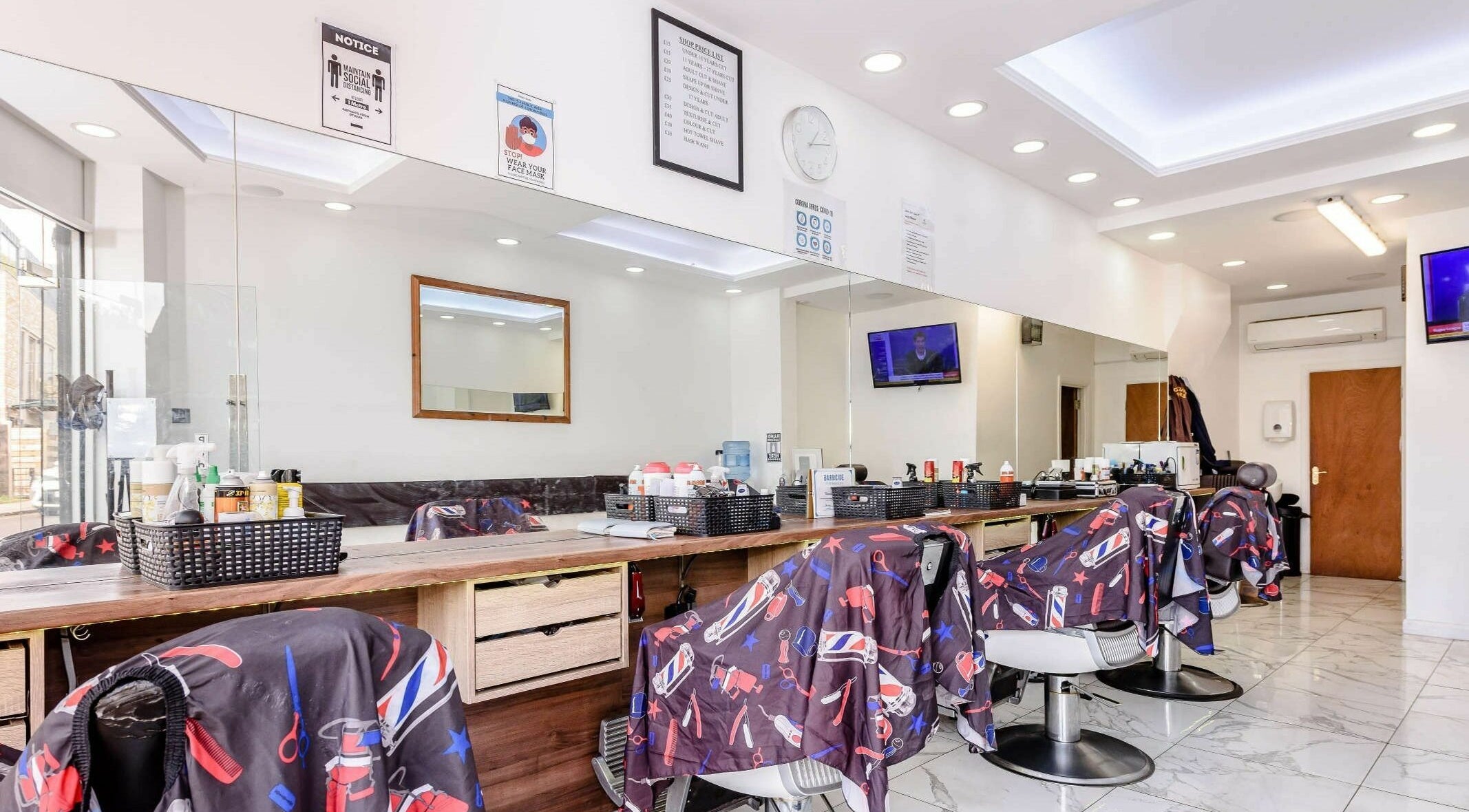 Clean Cuts London interior showcasing sleek barber chairs and mirrors. London, England, GB.