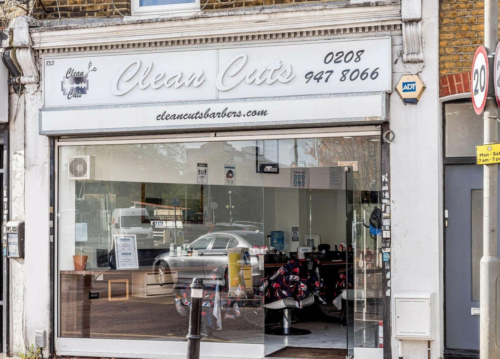 Exterior of Clean Cuts London barbershop in London, England, GB, featuring a modern glass front.