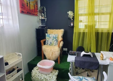 Cozy chair at The Finished Look Rodney Bay, Rodney Heights, St. Lucia, JM, adorned with lush cushions.