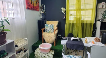 Cozy chair at The Finished Look Rodney Bay, Rodney Heights, St. Lucia, JM, adorned with lush cushions.