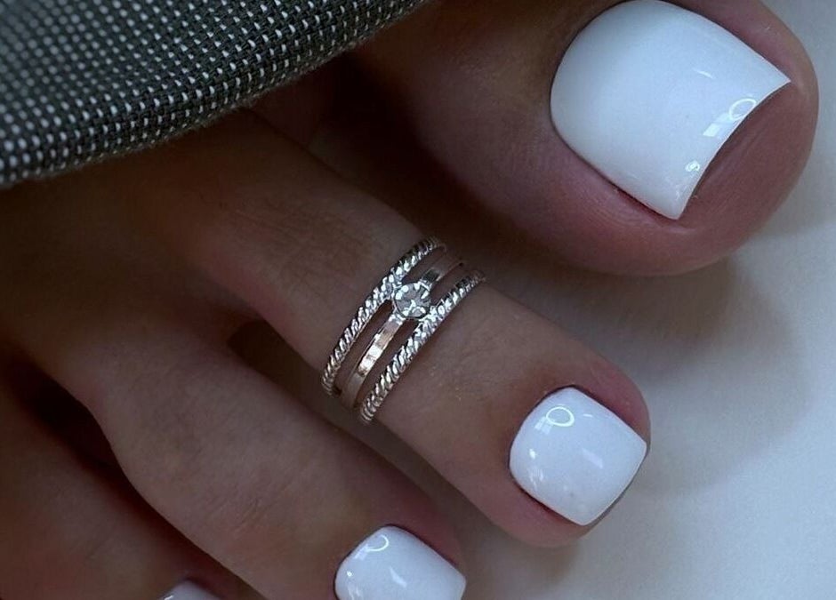 Chic white pedicure with rings at Lux Artistry, Cape Town, Western Cape, ZA showcasing elegance.
